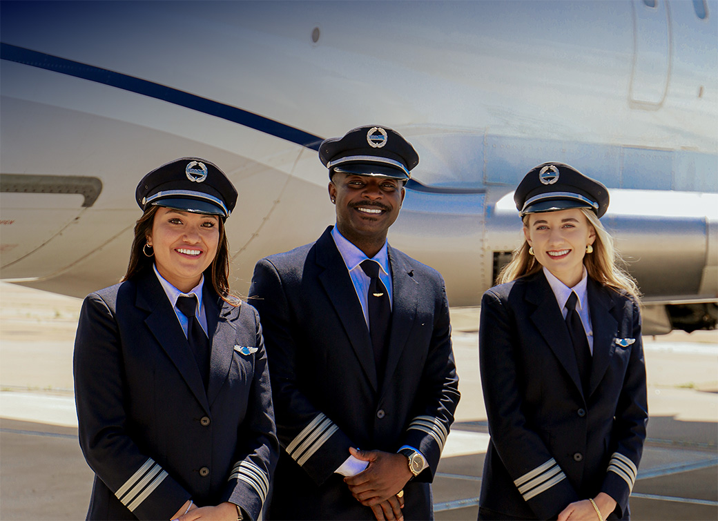 Pilots smiling in front of the CRJ-550 looking off to the side