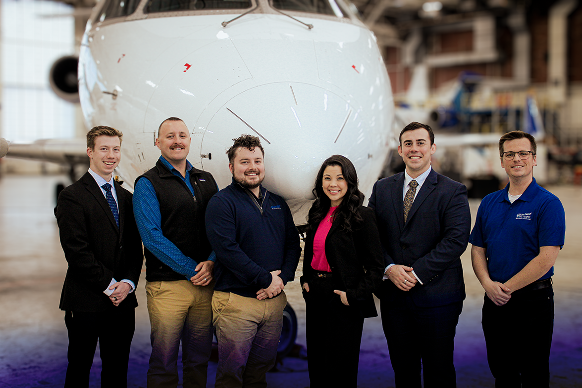 Group of Wingman standing in a line in front of a CRJ-550